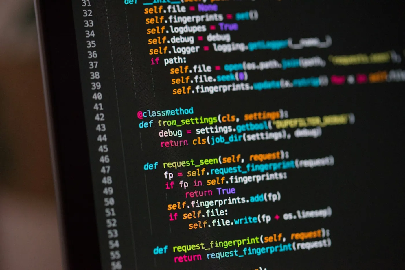 Source code on a dark editor screen, viewed at an angle